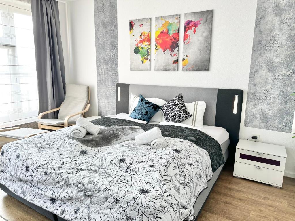 a bedroom with a bed with a black and white comforter at Design apartment Dresden centre - enjoy and relax in Dresden