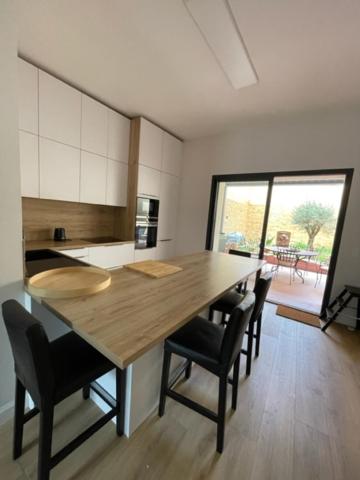 eine Küche mit einem großen Holztisch und Stühlen in der Unterkunft maison 15 mins du Mans in La Suze-sur-Sarthe