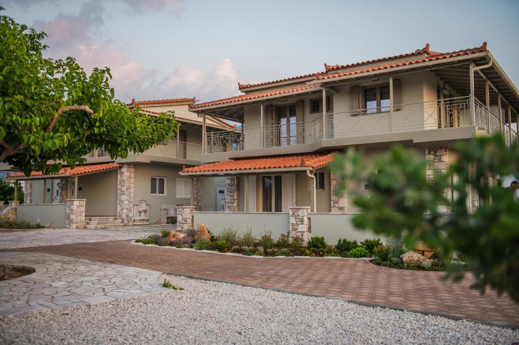a large house with a brick driveway in front of it at Terra Hélios Suites & Studios in Kyparissia