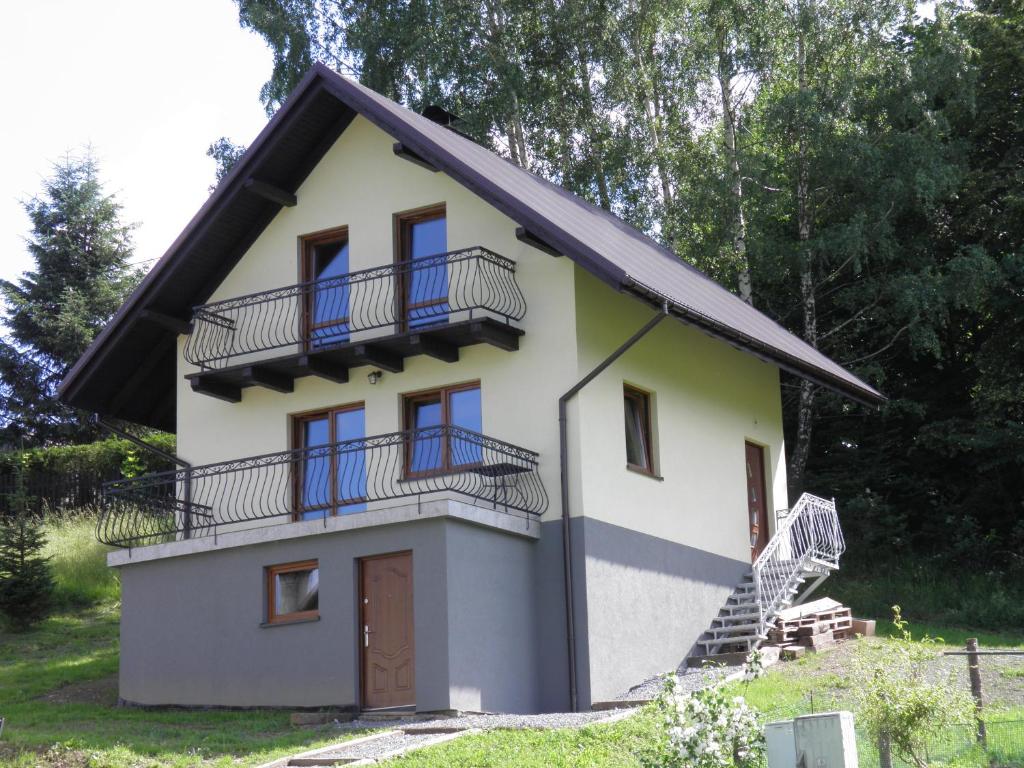 a house with balconies on the side of it at Domek pod Lipą in Korbielów