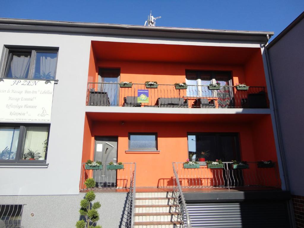 an orange and white building with a balcony at Chez Jpzen Nowicki in Freyming