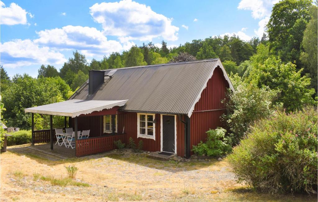 a red house with a metal roof at Beautiful Home In Backaryd With 2 Bedrooms in Backaryd