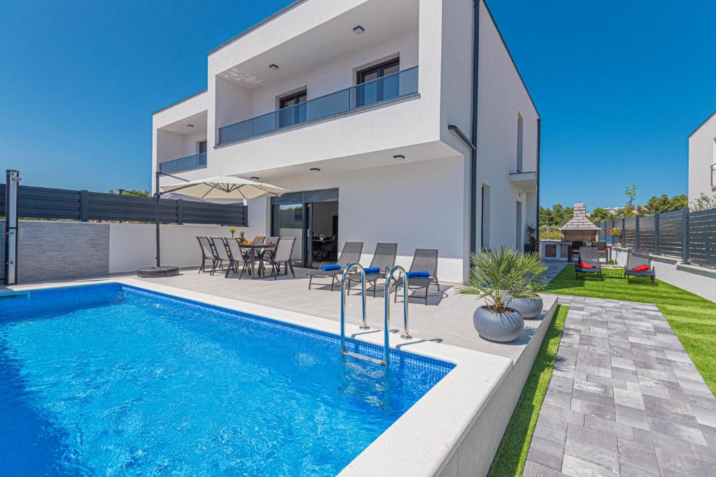 a villa with a swimming pool and a house at Villa Katarina Vodice in Vodice
