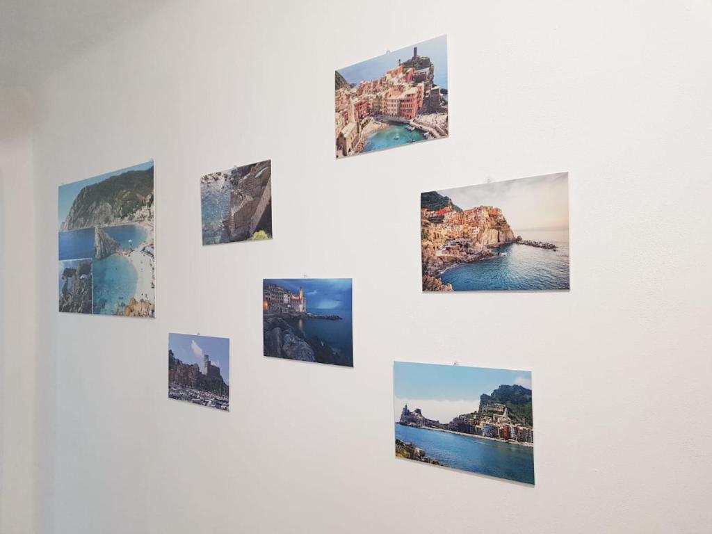 a group of photos hanging on a white wall at Casa Vacanze Matilde in La Spezia