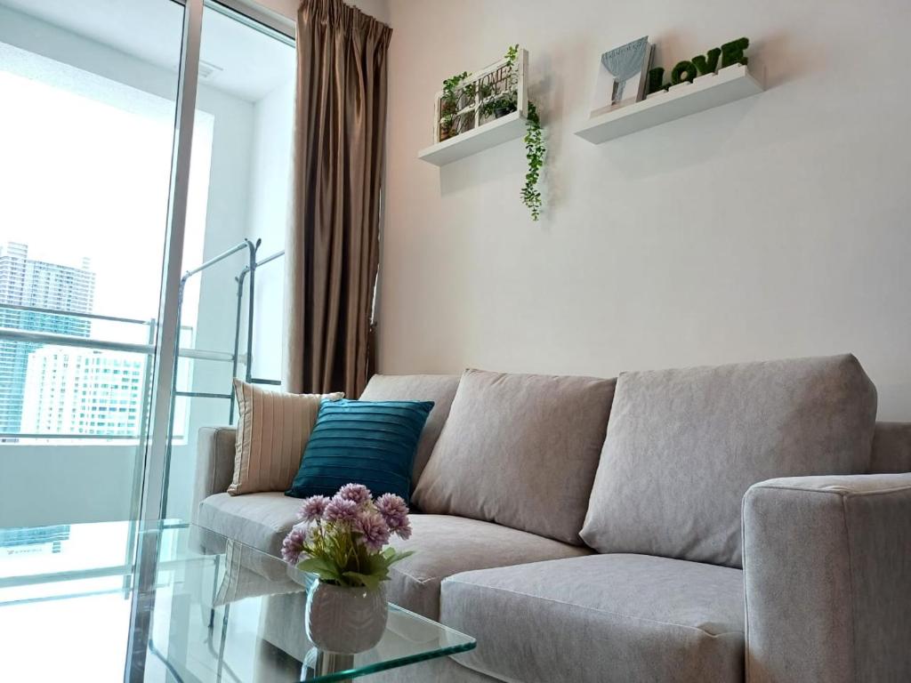 a living room with a couch and a glass table at Mansion One Seaview 2Bedroom 2Bathroom Georgetown Gleneagles Penang By AmrayHomes in George Town