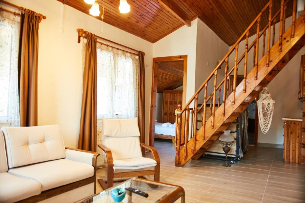 a living room with a couch and a staircase at İlçayto Suites in Foça