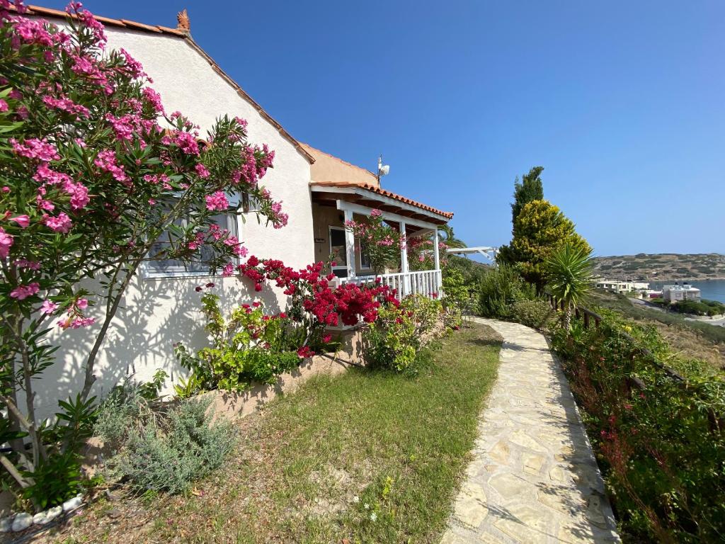 a house with flowers on the side of it at Vaia Villas in Mochlos