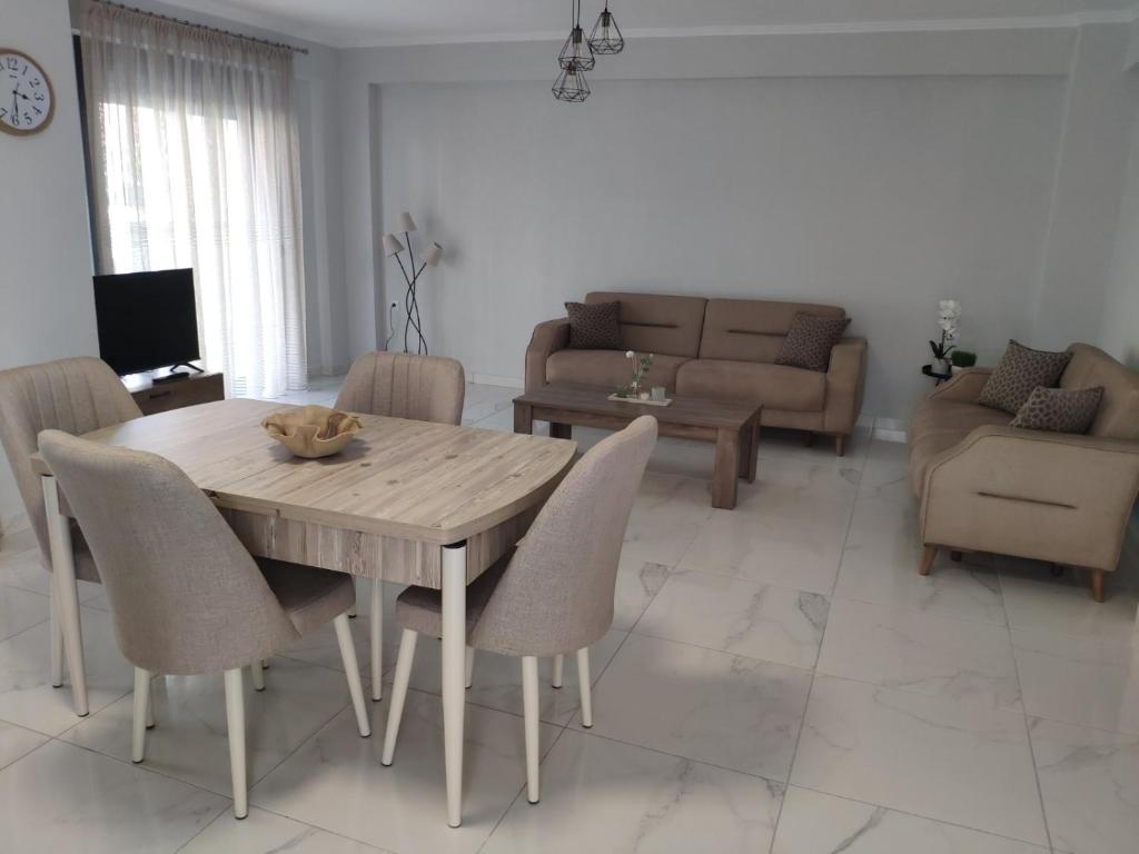 a living room with a wooden table and chairs at Family house in Ofrínion