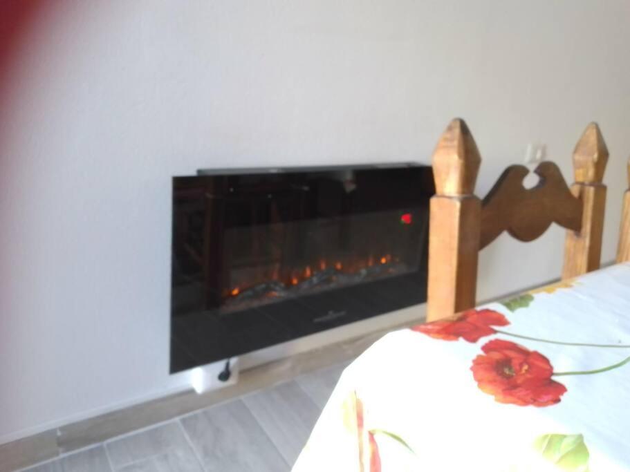 a fireplace in a bedroom with a bed and a fire place at monolocale CRIS in Madesimo