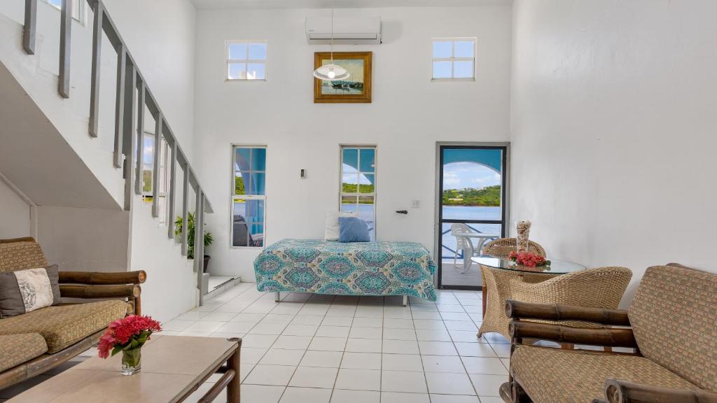 a living room with a couch and a table at Edwards Guesthouse in Sandy Ground Village