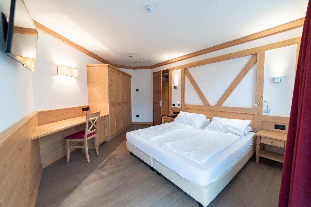 Postel nebo postele na pokoji v ubytování Hotel Garnì Paradisi - Wellness & Spa