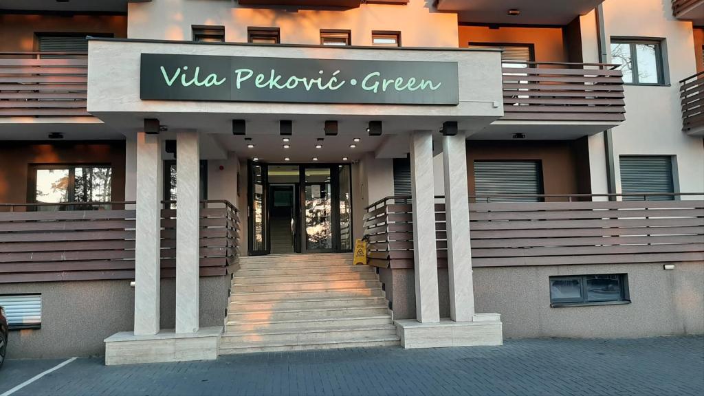 a building with a sign that reads villa positivo green at Lana in Zlatibor