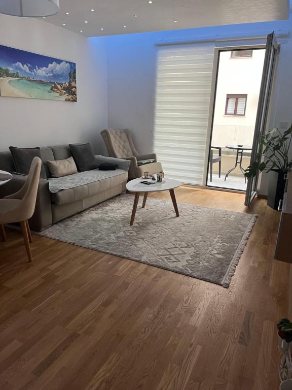 a living room with a couch and a coffee table at Apartman Jakov in Bečići