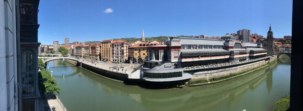 a large boat in a river in a city at Old Town & River (Casco Viejo Bilbao) E-BI 1138 in Bilbao