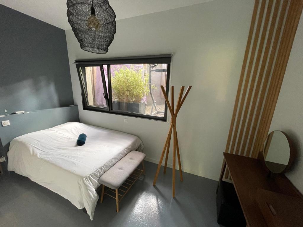 a small bedroom with a bed and a window at L’atelier d’Alain in Maxéville