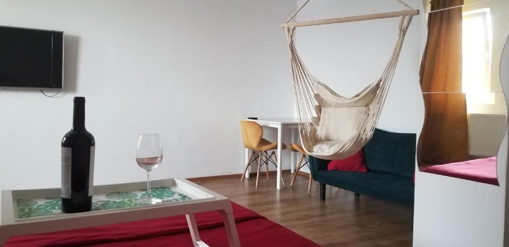 a living room with a hammock and a wine glass at Private room at Ceausescu's place in Old City Unirii Square in Bucharest