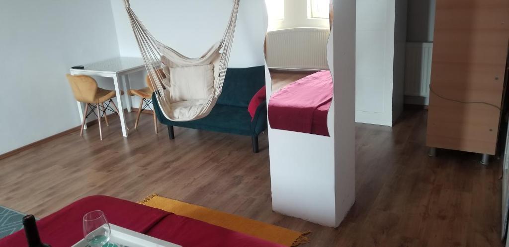 a room with a bed and a hammock in a room at Private room at Ceausescu's place in Old City Unirii Square in Bucharest