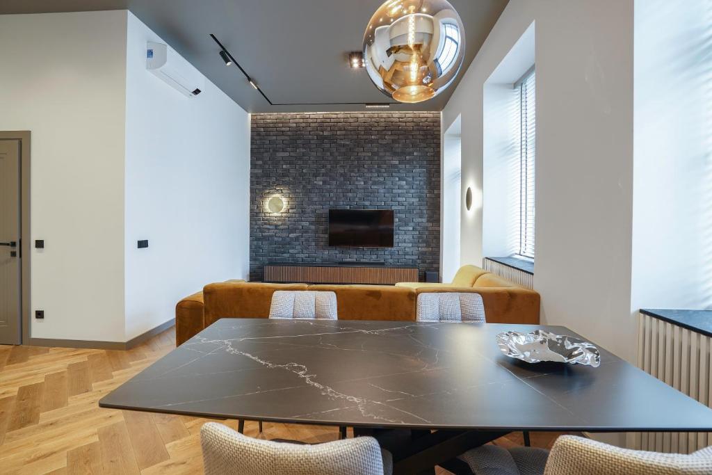 a dining room with a table and chairs and a fireplace at Forentinn Gedimino pr. in Vilnius