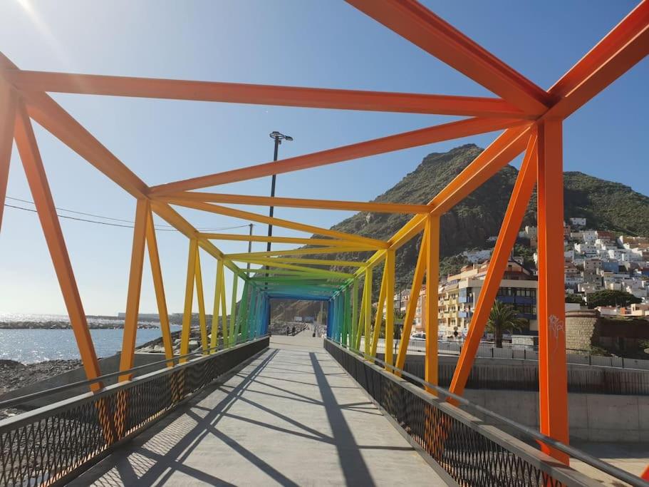 a bridge over a beach with orange and green at Las Teresitas Apartment in San Andrés