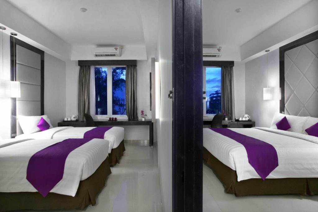 Postel nebo postele na pokoji v ubytování Quest Hotel Balikpapan by ASTON
