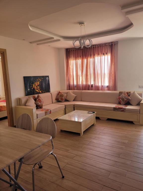 a living room with a couch and a coffee table at Dar Bhar in Kelibia