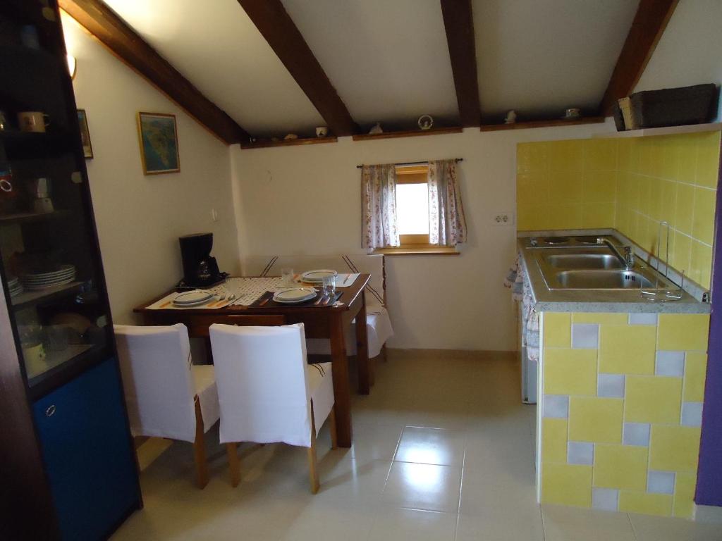 a small kitchen with a table and a sink at Studio Apartment Nera in Rovinj