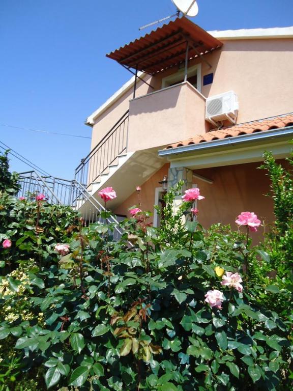 a building with a bunch of flowers in front of it at Studio Apartment Nera in Rovinj