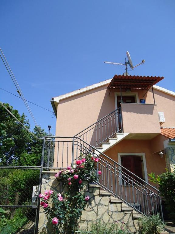 a house with a staircase and flowers on it at Studio Apartment Nera in Rovinj