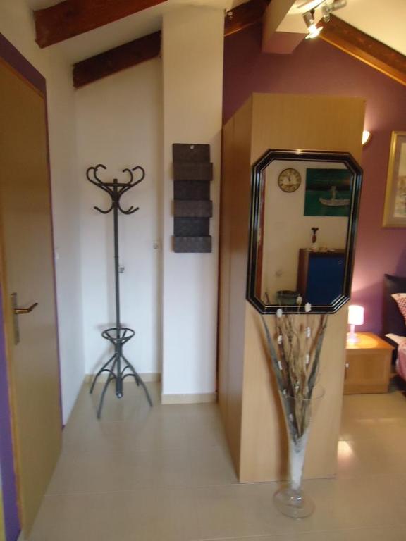a room with a vase and a mirror on the floor at Studio Apartment Nera in Rovinj