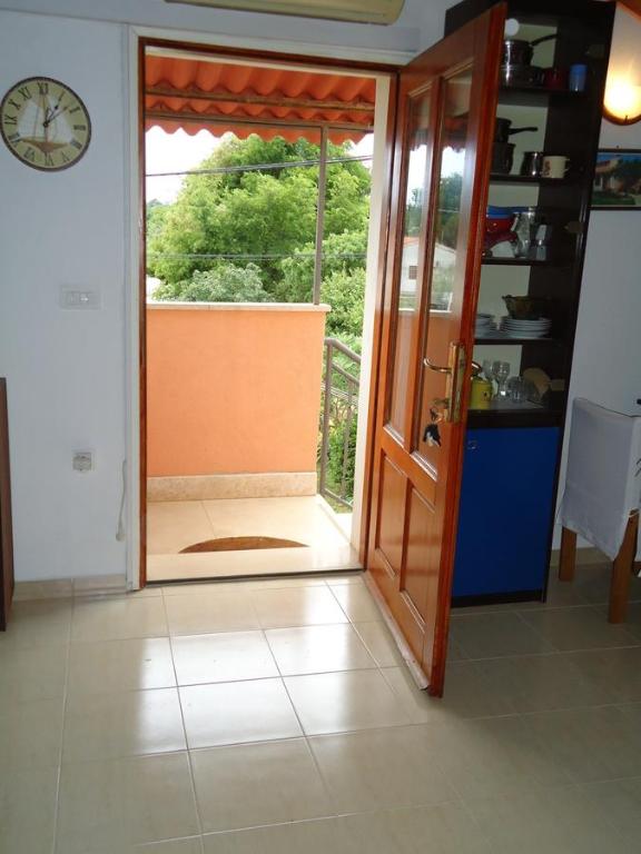 a room with a door open to a balcony at Studio Apartment Nera in Rovinj