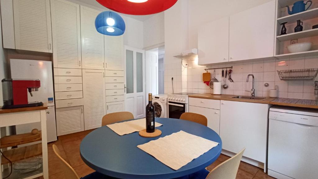 a kitchen with a table with a bottle of wine on it at Apartment LAUREL Center Opatija in Opatija