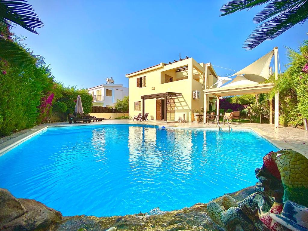 a large swimming pool in front of a house at Villa Victoria Ayia Napa in Ayia Napa