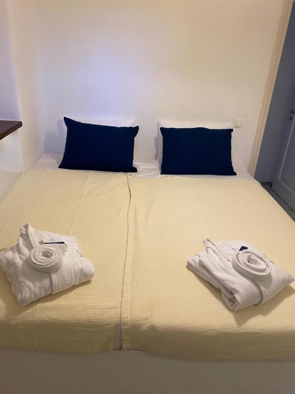 a bed with two towels sitting on top of it at Delta Apartment in Chrissi Akti