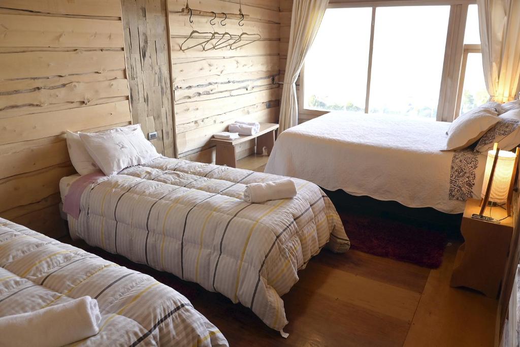 Postel nebo postele na pokoji v ubytování Hotel Boutique Antukenu