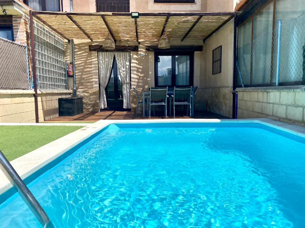 a swimming pool in the backyard of a house at La espiga de la Mata in Segovia