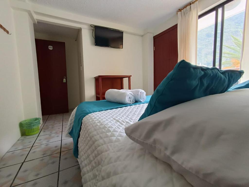 Postel nebo postele na pokoji v ubytování Hostal CañaLimeña