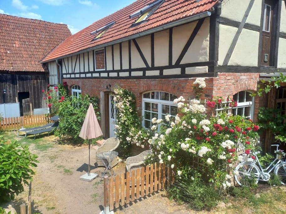 a house with a bunch of flowers in front of it at Romantisches Rosencottage in Hofheim in Unterfranken
