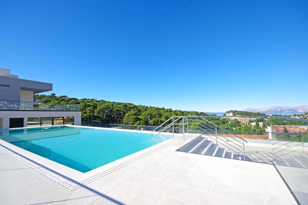 a swimming pool on the side of a house at ATLANTIS LUX with pool in Makarska