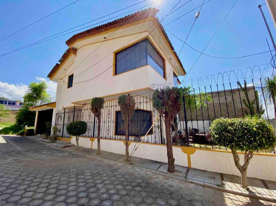 a house with a fence in front of it at Casa Estrella Oaxaca in Oaxaca City