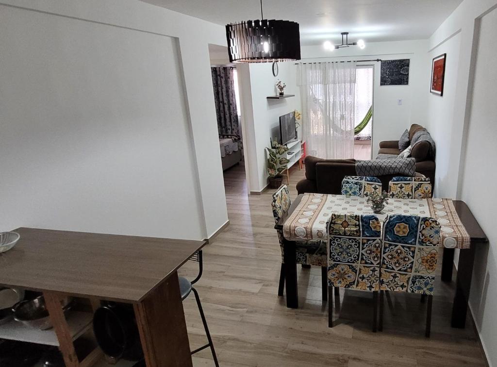 a living room with a table and a couch at Apto praia pontal, vista mar in Rio de Janeiro