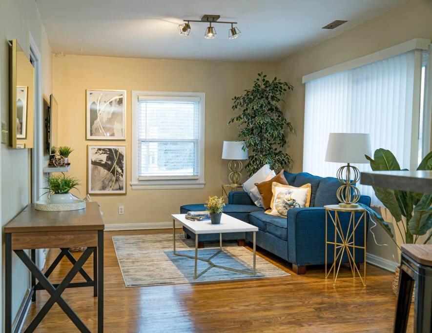 a living room with a blue couch and a table at Home Away in Erie