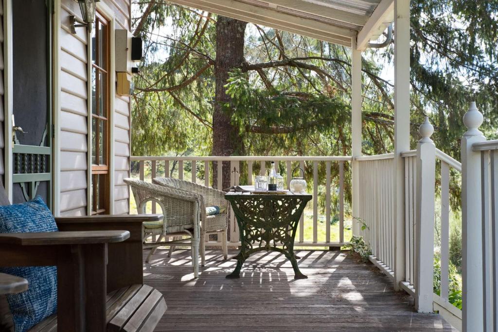 a porch with a table and chairs on it at All Views in Daylesford