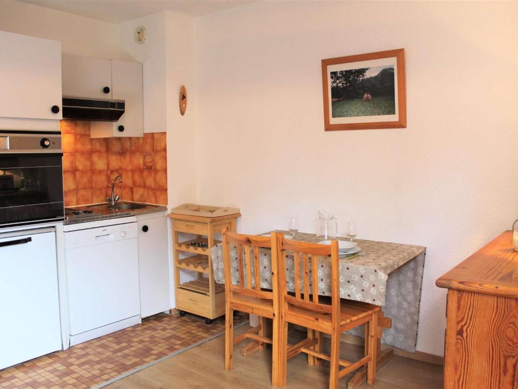 a kitchen with a table and chairs and a kitchen with a sink at Studio confortable pour 2, pieds des pistes, centre station Vars Les Claux - FR-1-330B-210 in Vars