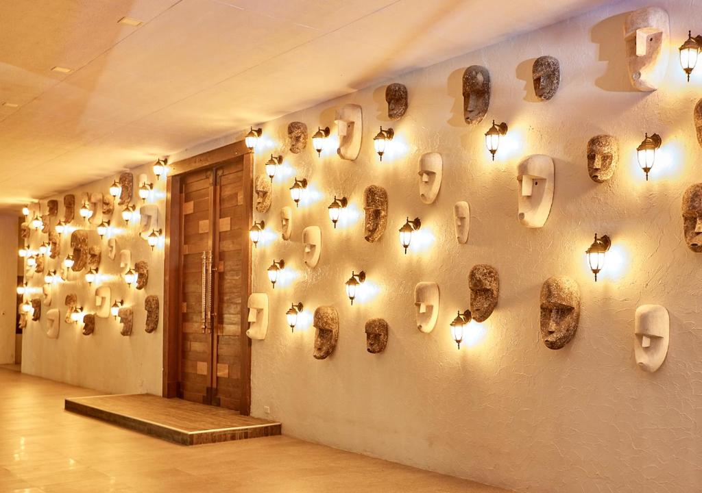 a wall with skulls on a wall with lights at Tag Resort in Coron
