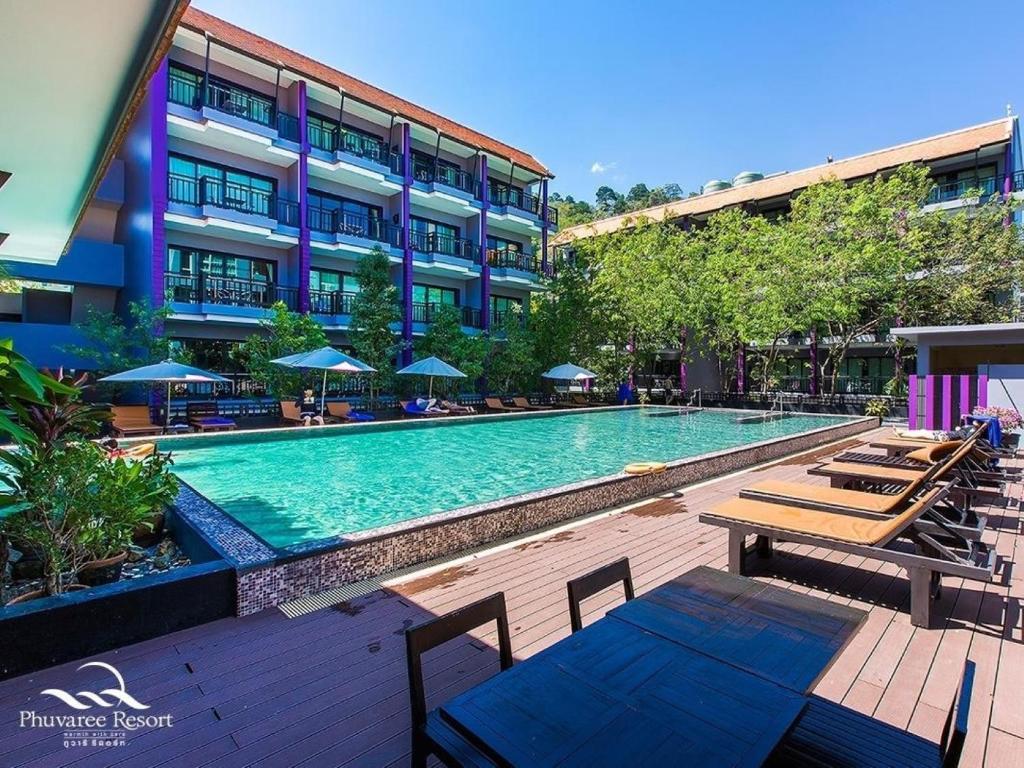 a swimming pool in front of a building at Phuvaree Resort in Patong Beach