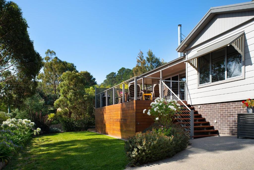 a house with a deck on the side of it at Arabella Meadows in Daylesford