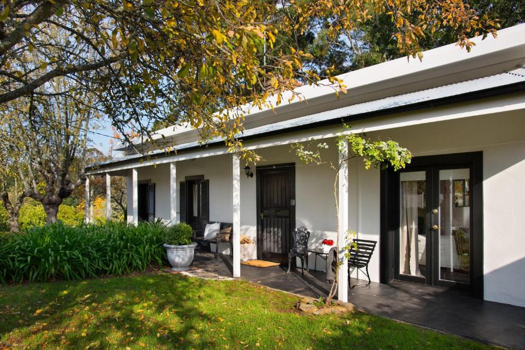 a white house with a patio and a yard at Aysgarth in Daylesford