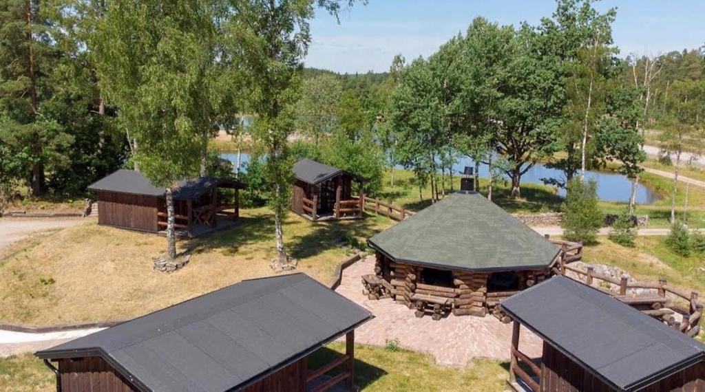 an aerial view of a resort with buildings and a lake at Svensson's Log Cabins in Osby