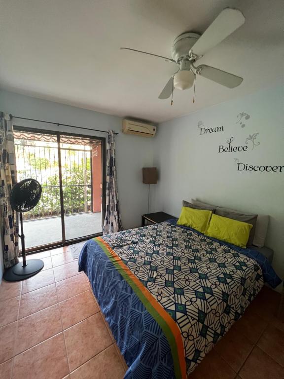 ココにあるMariposa End Unit Loftのベッドと天井扇風機のある寝室