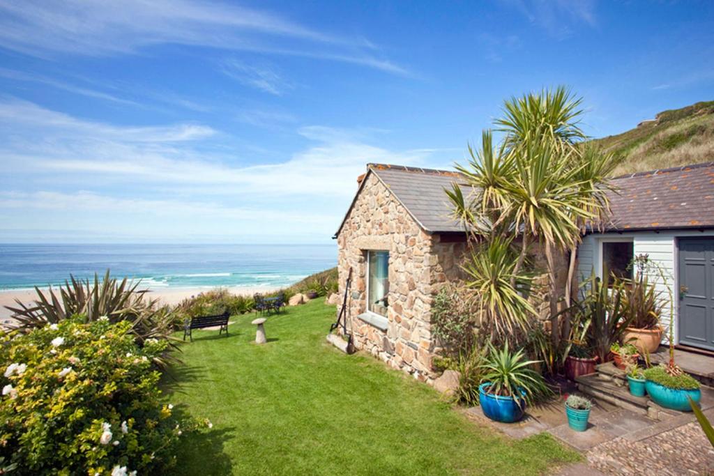 a small stone house with a view of the ocean at Sheldrake, Spacious Villa, Panoramic Sea-views, Large Garden, By Beach in Sennen